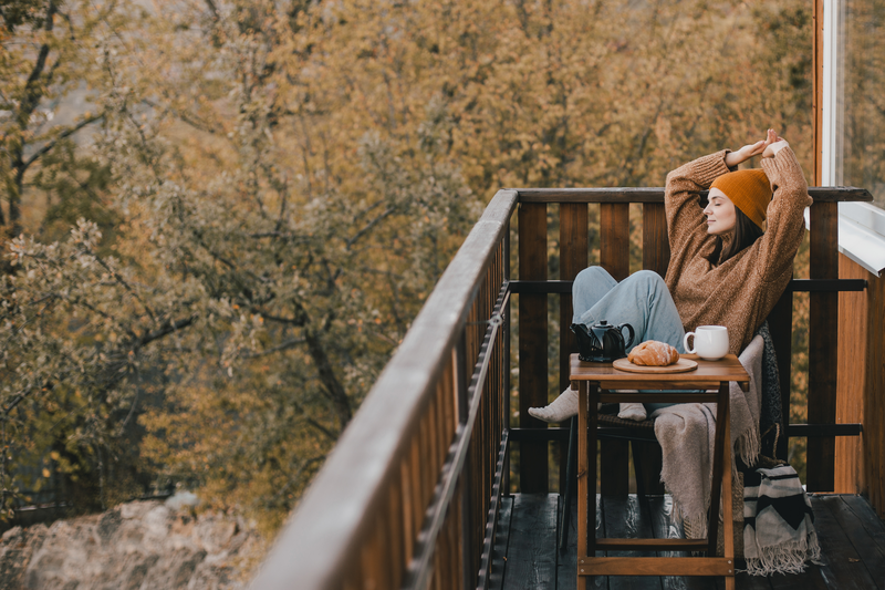 woman enjoying breakfast while relaxing on cabin deck