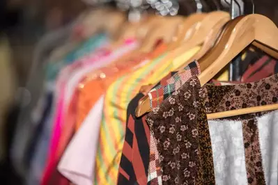 shirts on a rack at a thrift store