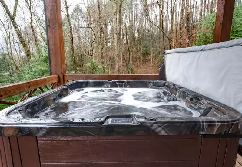 A bubbling hot tub on a cabin deck in Murphy NC.