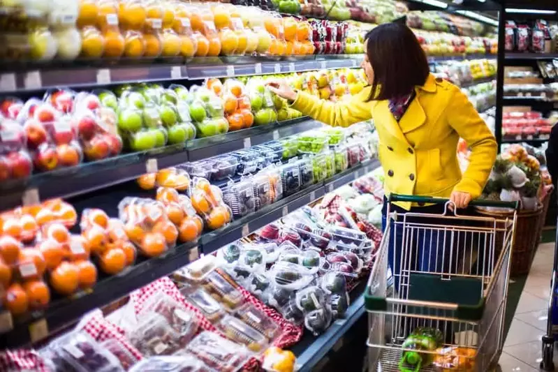 woman grocery shopping picking out vegetables