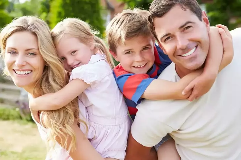 Happy family, parents with children on back