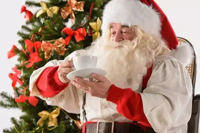 Santa drinking hot cocoa.