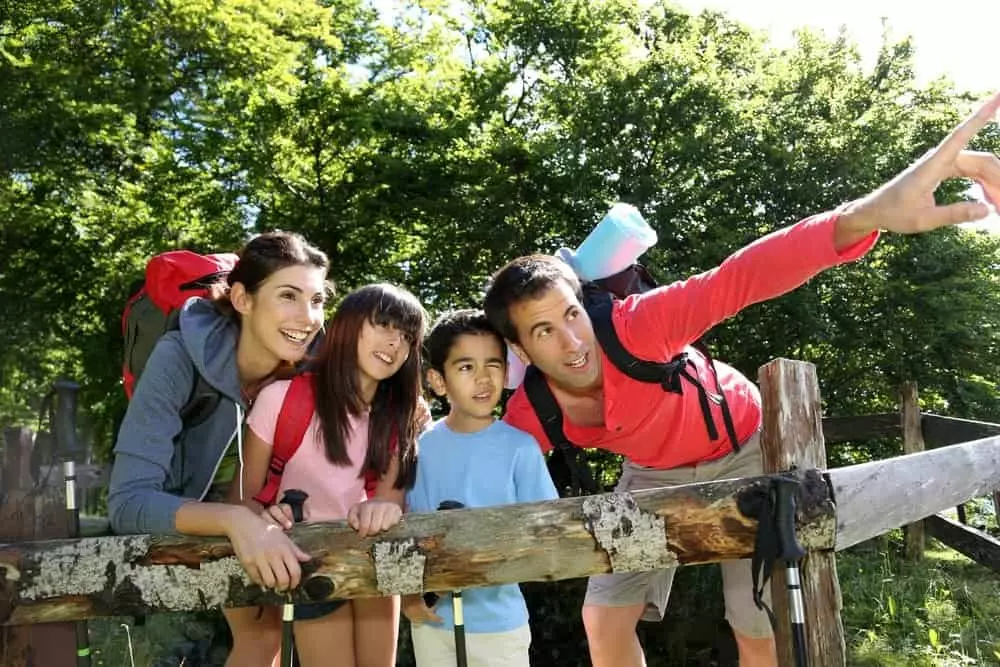 A family hiking in the forest.