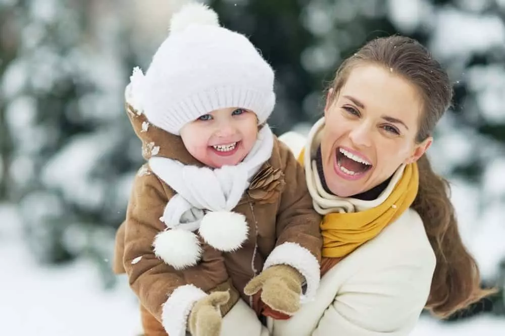 Happy woman and young daughter in winter jackets near our Murphy North Carolina cabin rentals.