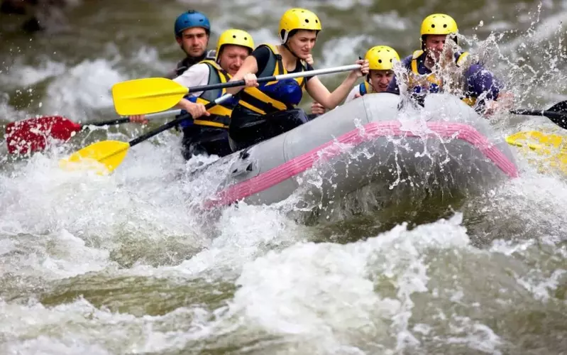 A group of friends white water rafting.