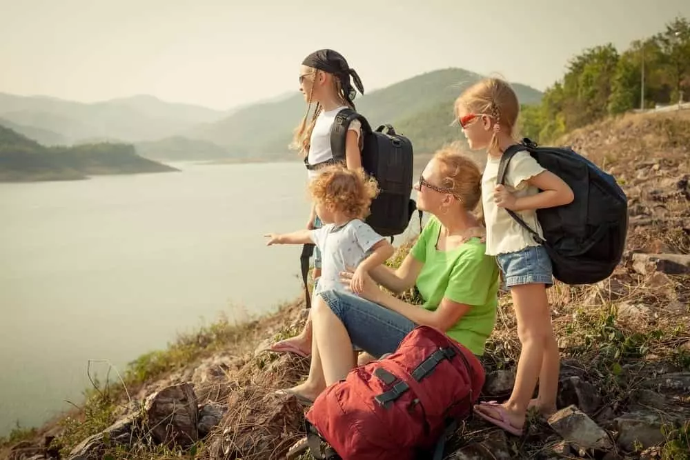 Family sitting by the lake near our cabin rentals in Murphy NC.