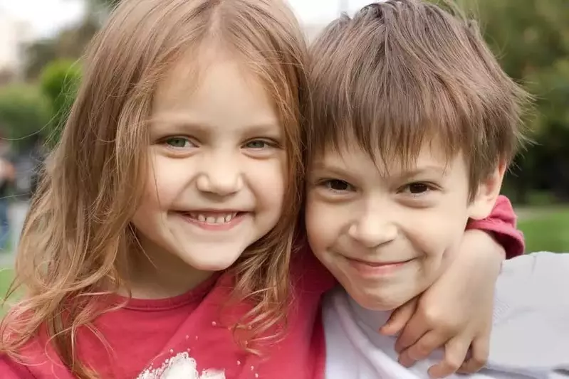 Happy siblings in front of our cabin rentals in Murphy NC.