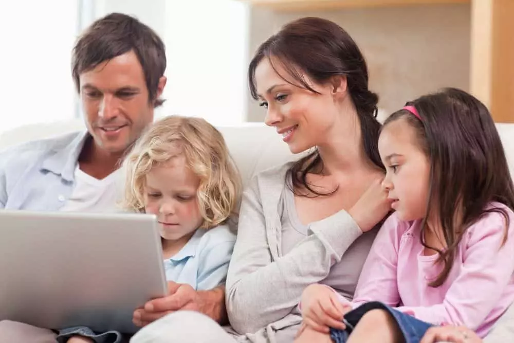 Family surfing the web together on a tablet in their Murphy NC cabin with internet access.