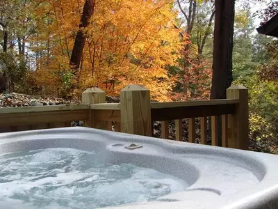 Bubbling hot tub with a scenic autumn view at a two bedroom cabin in Murphy NC