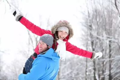 Couple frolicking in the snow