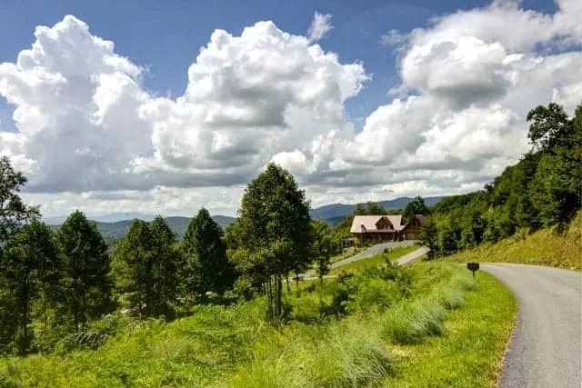 mountain and log cabin view of blue sky